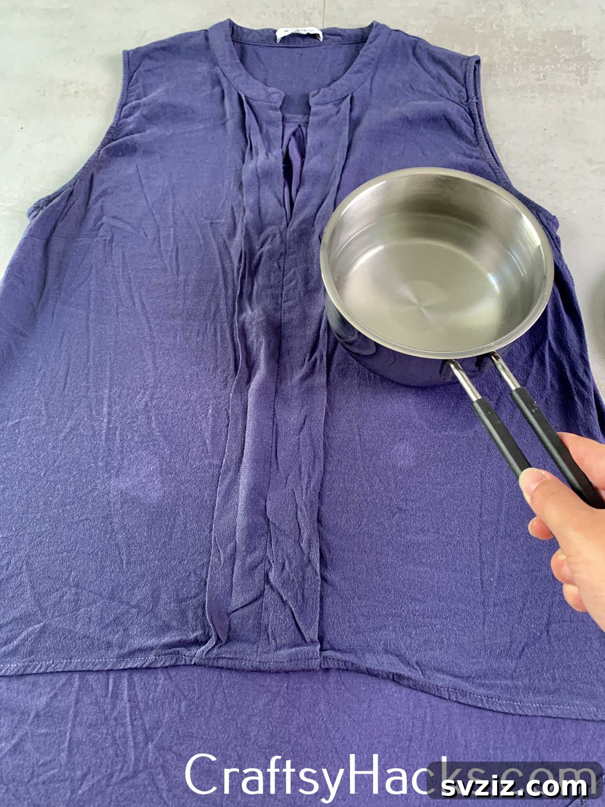 Smooth out wrinkles on delicate fabrics or clothing without an iron by using the hot, residual temperature of a pot of boiling water, acting as a makeshift steamer.
