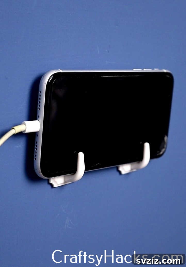 Utilize Command Hooks to create a neat and accessible charging station for your phone, keeping cables organized and your device off countertops. This is a smart decluttering hack.