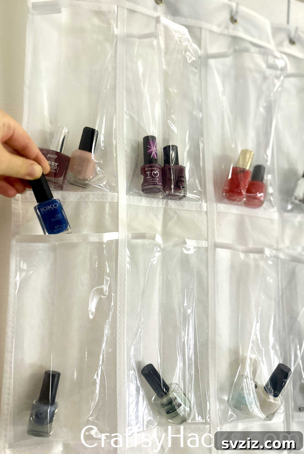 Organize a large collection of nail polish by color in the clear pockets of an over-the-door shoe organizer.