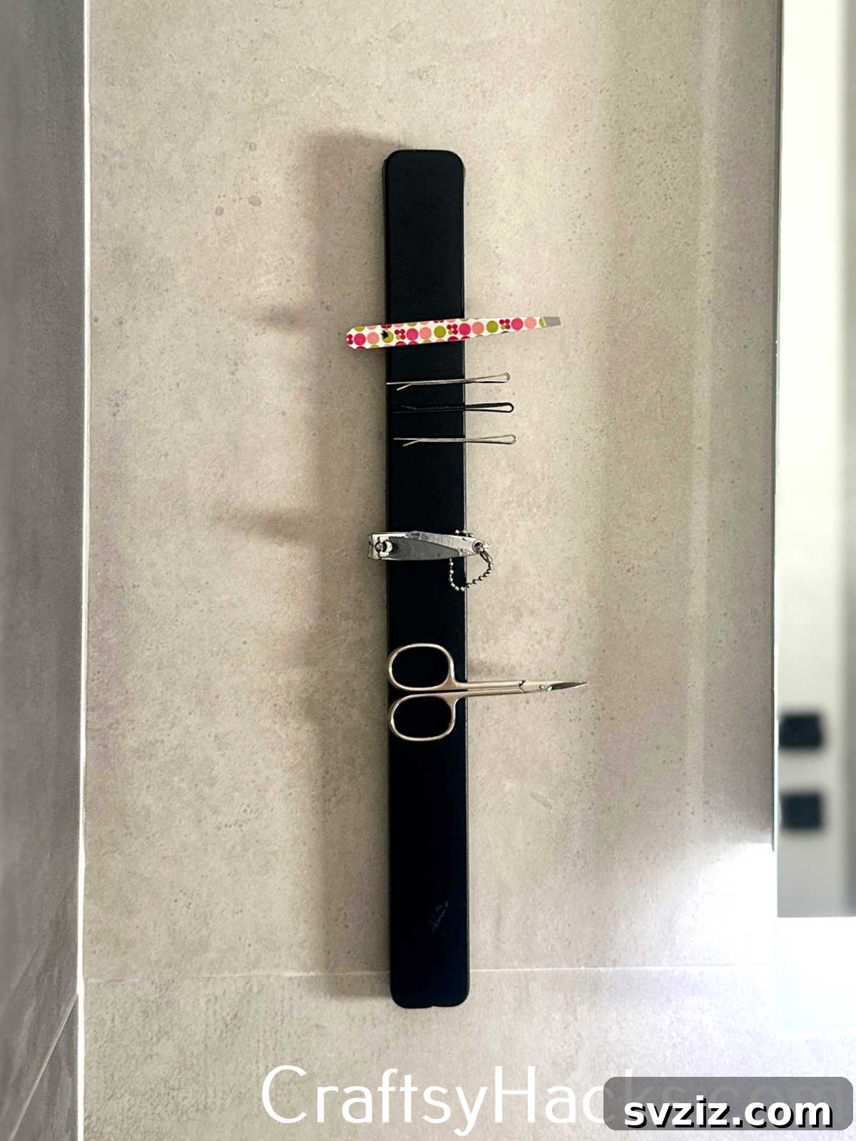 Install a magnetic strip on your wall to keep small metal grooming tools like tweezers and nail clippers organized and visible.