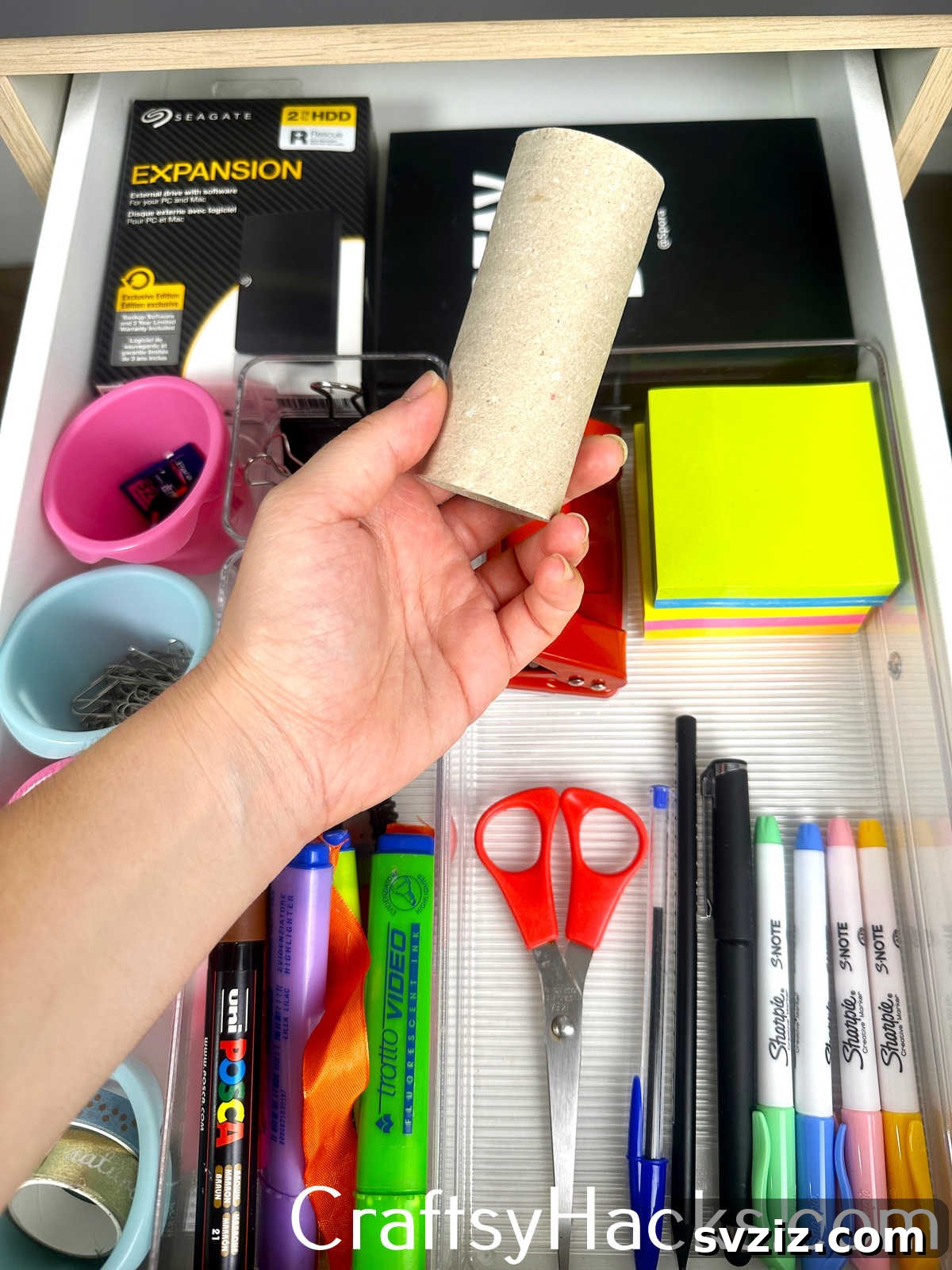 Repurpose an empty toilet paper roll to keep small stationery items like pens, pencils, or loose papers neatly contained.