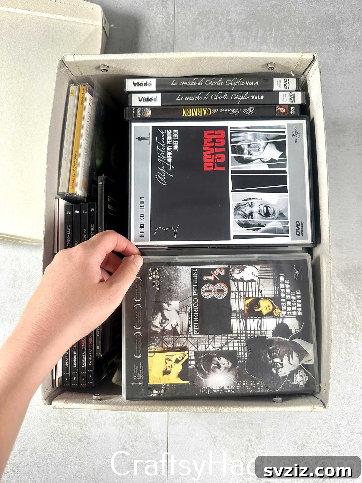 Store DVDs compactly in decorative boxes or containers to save space and keep media collections tidy.