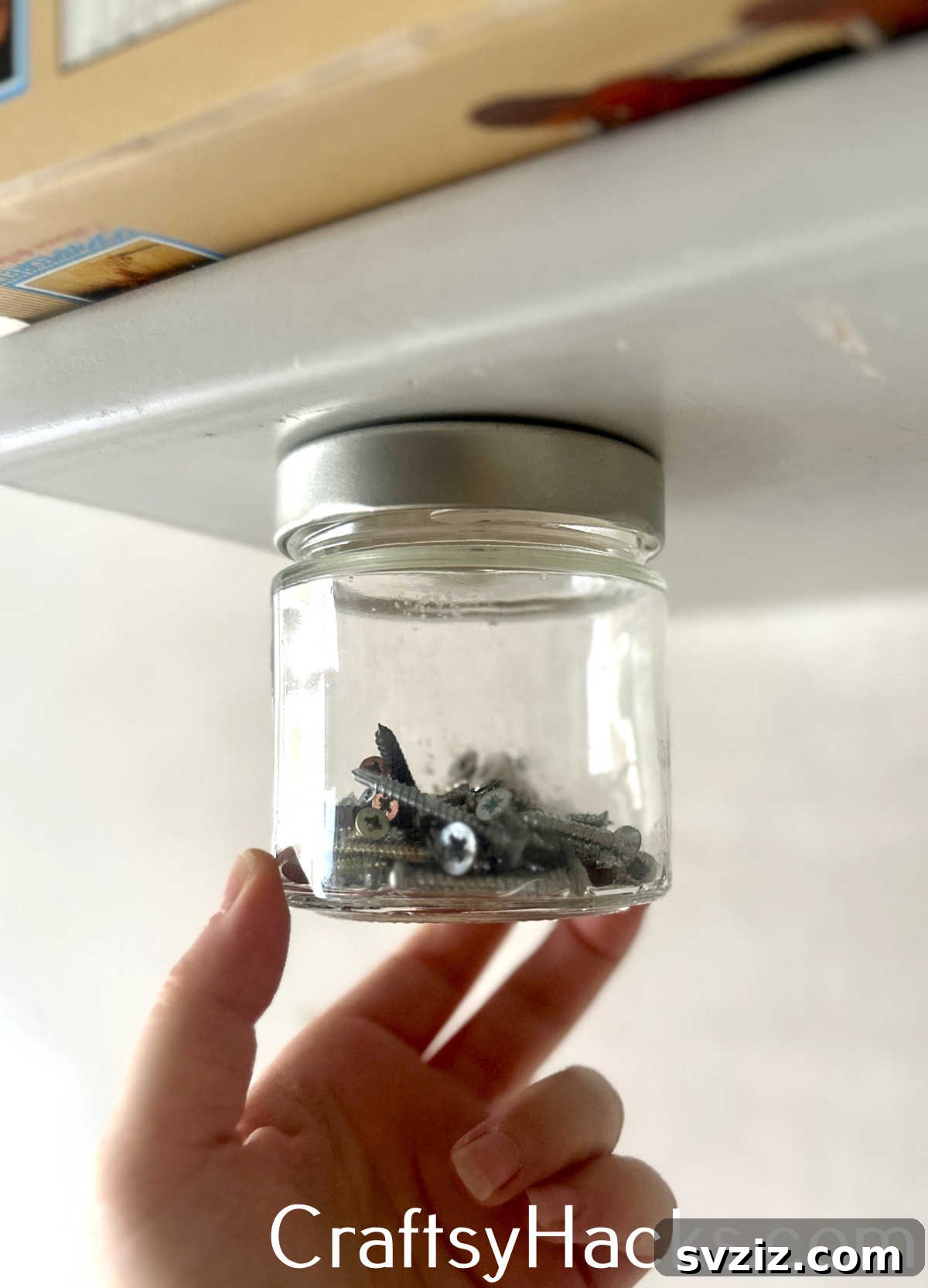 Create clever under-shelf storage by screwing jar lids to a wooden surface and attaching matching jars for small items.