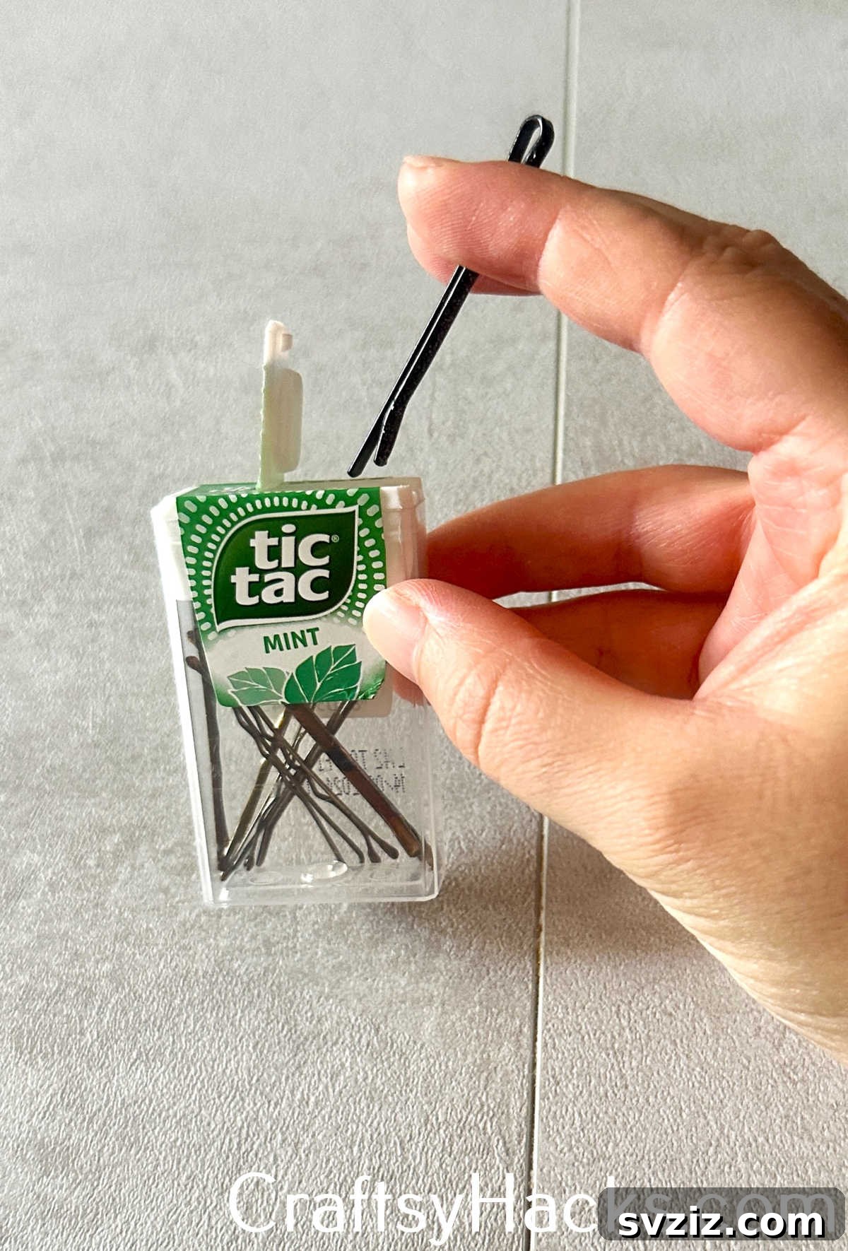 Repurpose an empty mint container into a compact and portable case for bobby pins.