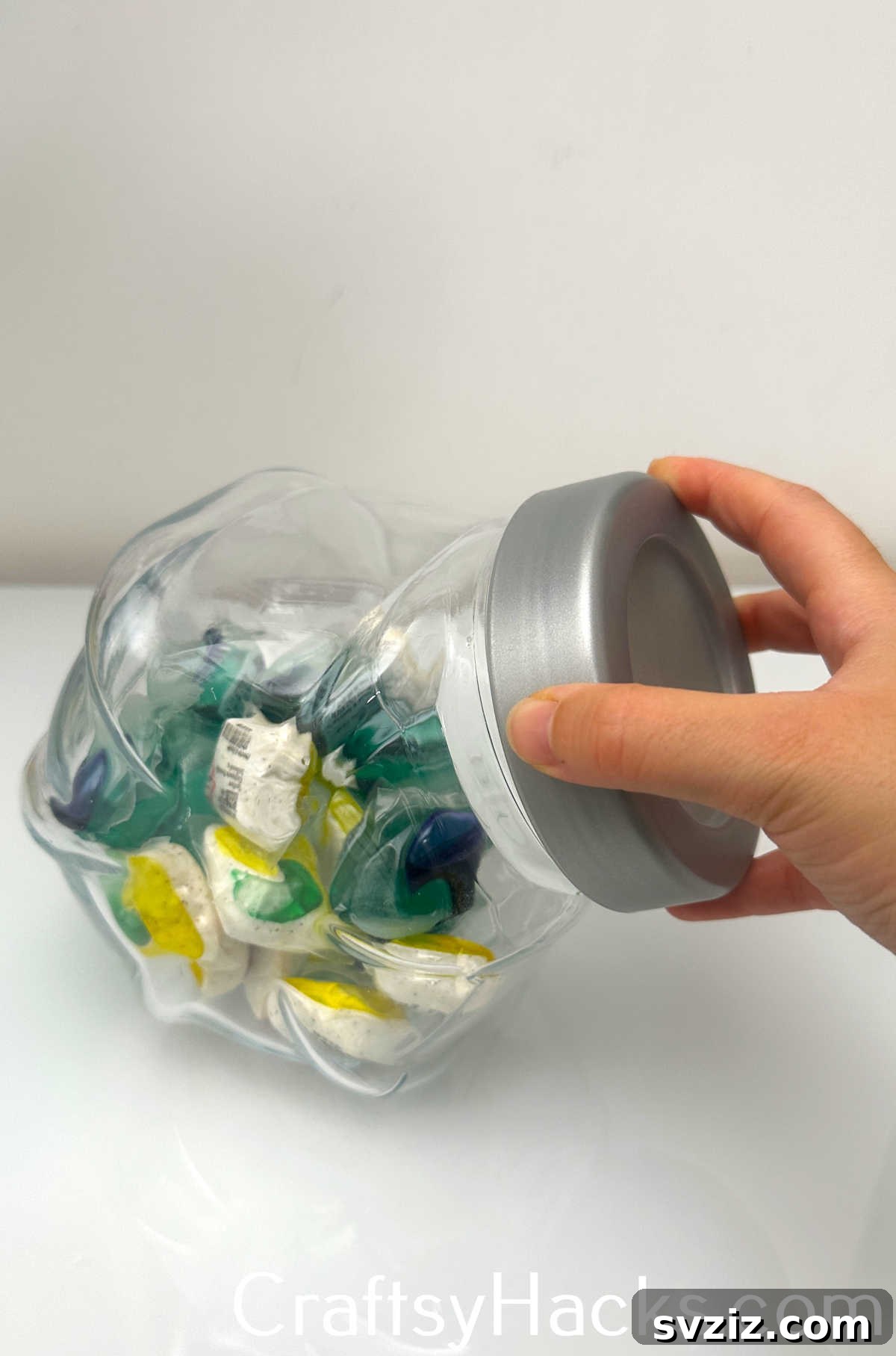 Decoratively store laundry pods in a stylish cookie jar to keep them tidy and out of reach.