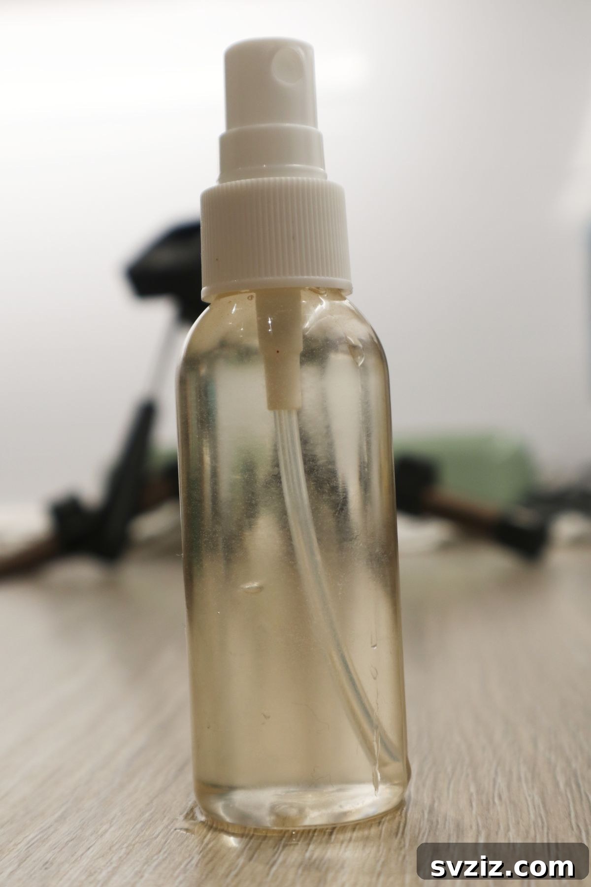 The Pantry Secret for a Rust-Free Oven 4 A spray bottle filled with vinegar, essential for activating the baking soda during oven rack cleaning.