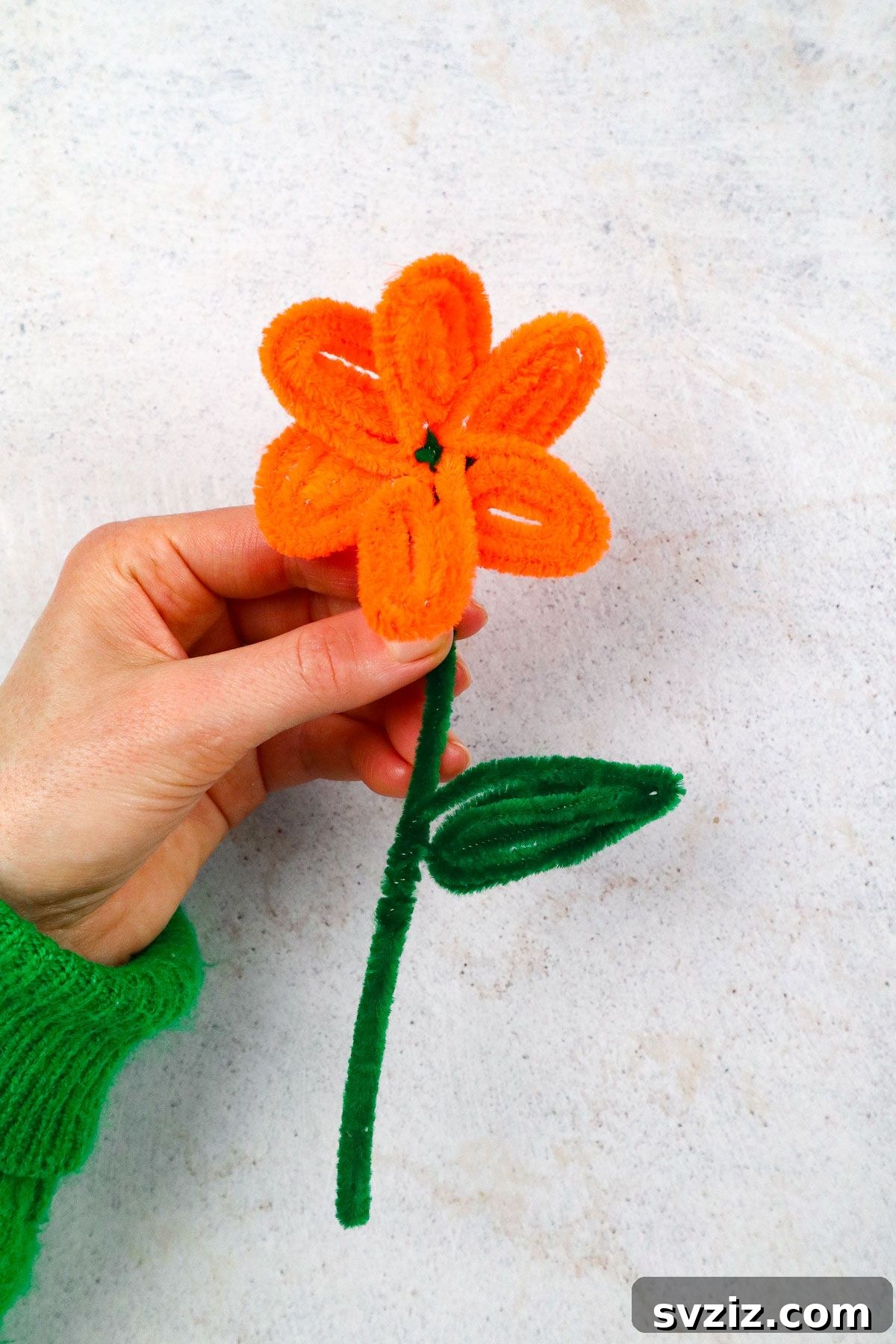 Fuzzy Floral Creations 10 A stunning close-up of a completed DIY pipe cleaner flower, highlighting its detailed petals and bright colors.