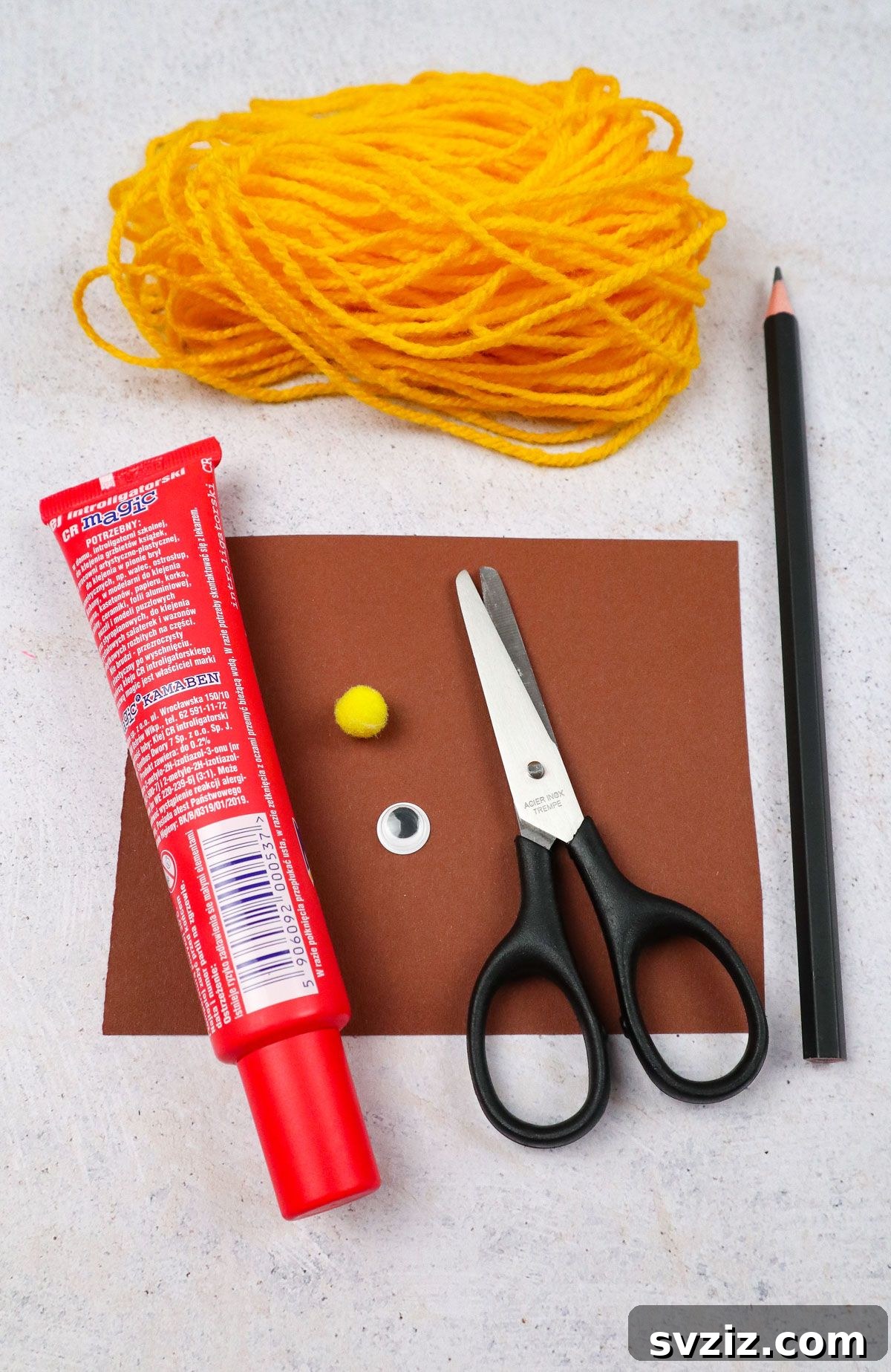 Craft an Adorable Pom Pom Hedgehog 3 Supplies for DIY pom pom hedgehog craft including yarn, googly eye, craft paper, scissors, pencil, small pom pom, and craft glue