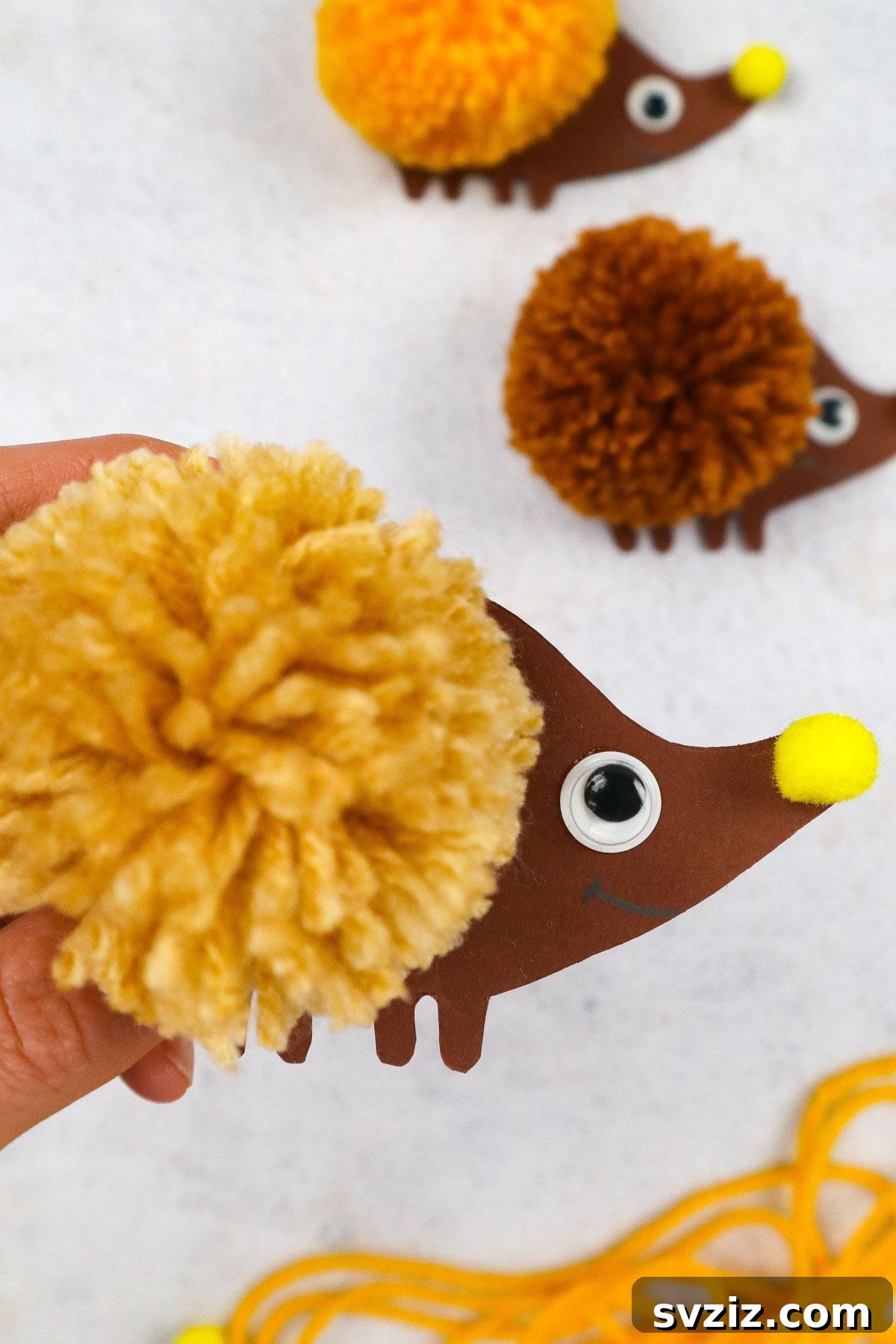Craft an Adorable Pom Pom Hedgehog 6 Adorable completed DIY pom pom hedgehog