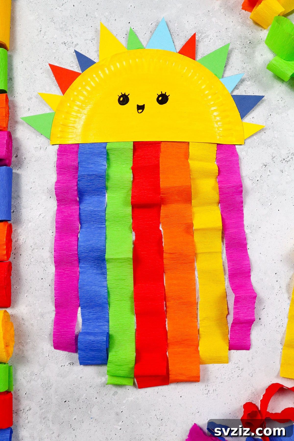 Craft Your Paper Plate Rainbow 2 Smiling paper plate rainbow craft with colorful streamers