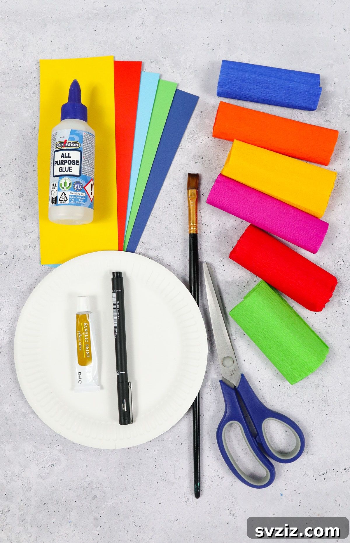 Craft Your Paper Plate Rainbow 3 Craft supplies neatly arranged for paper plate rainbow project