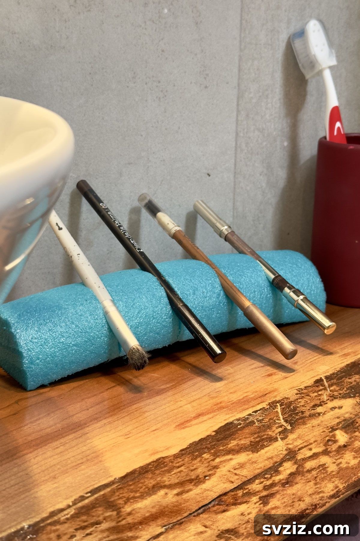 Makeup organization idea: using a pool noodle to store brushes and eyeliners