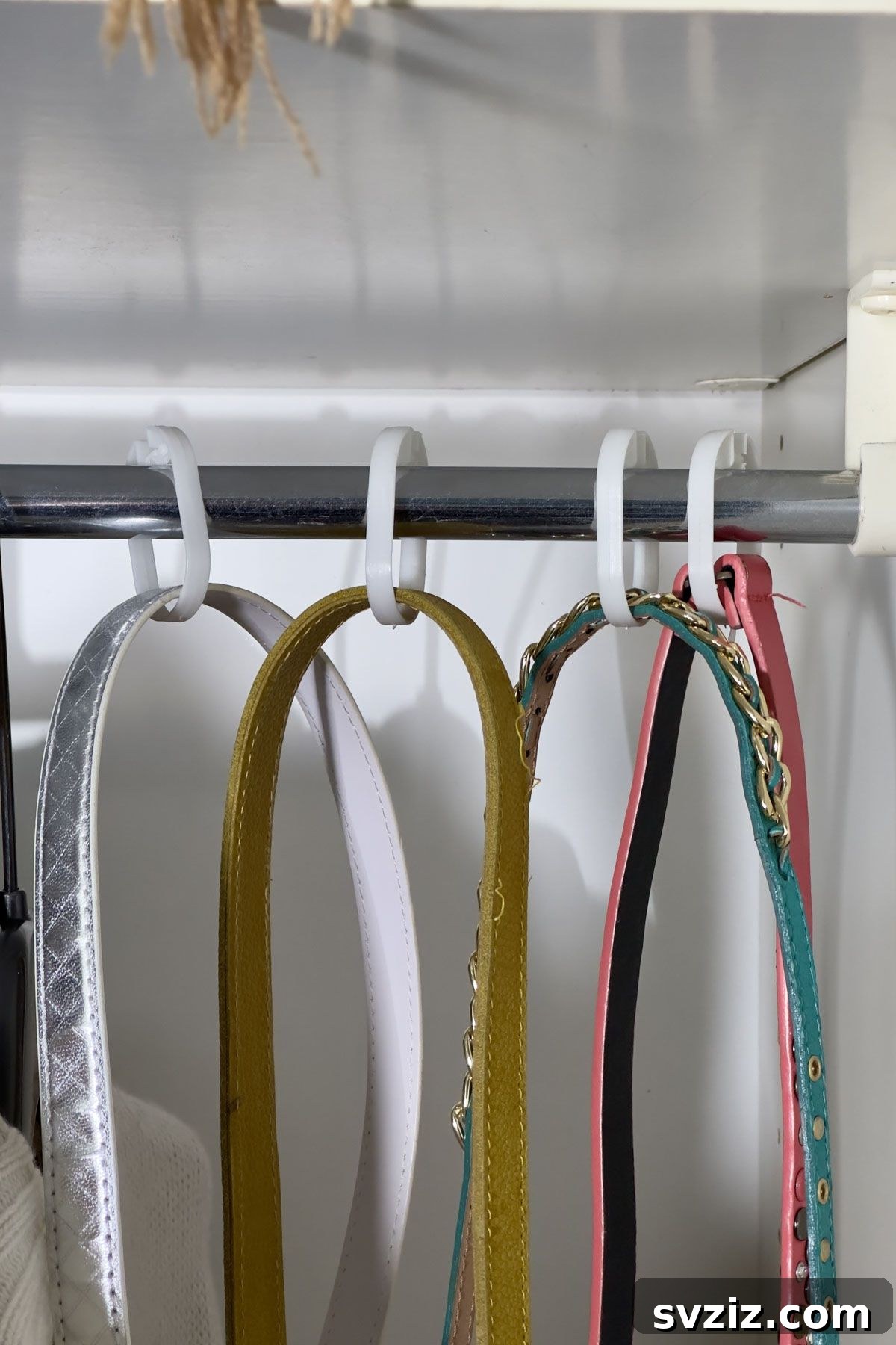 Closet organization hack: using shower hooks to organize belts