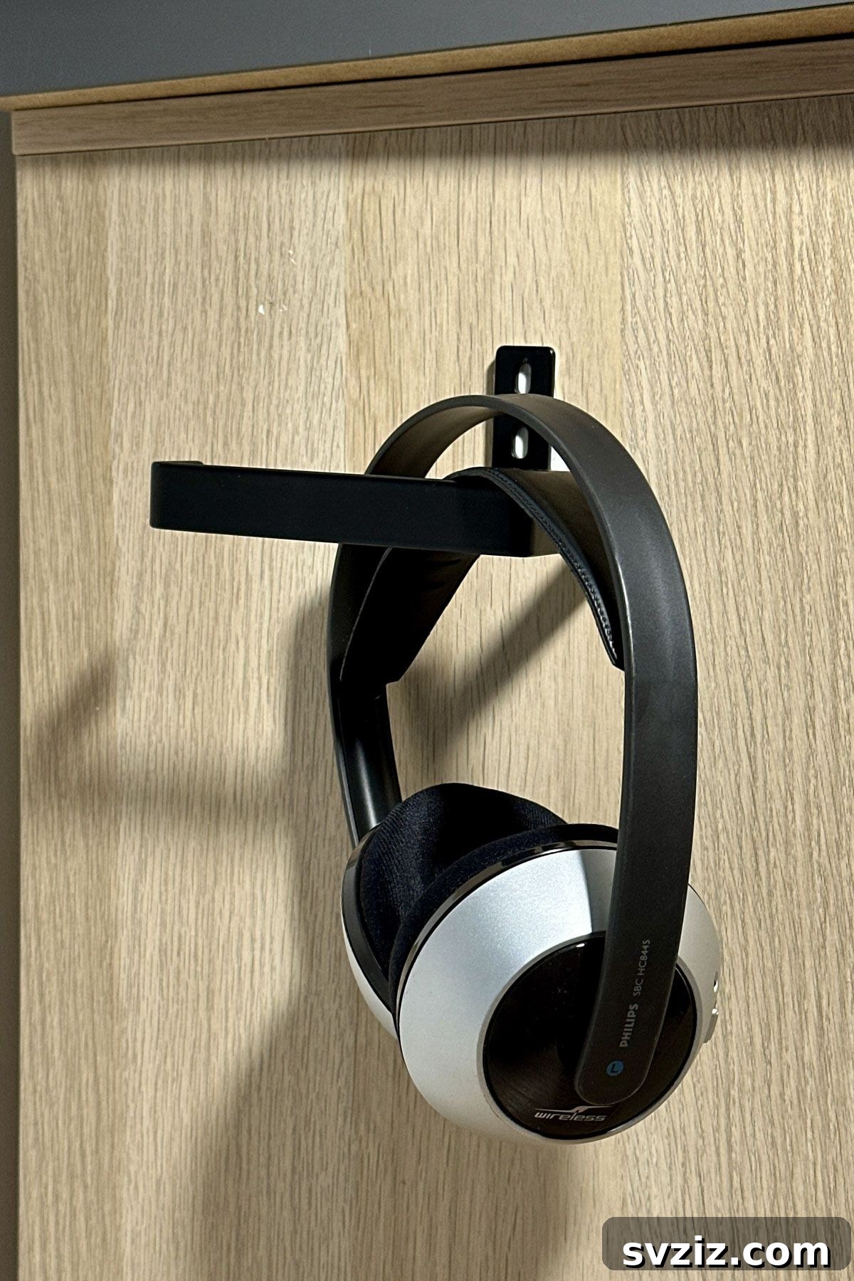 Desk organization: using a toilet paper roll holder to hang headphones