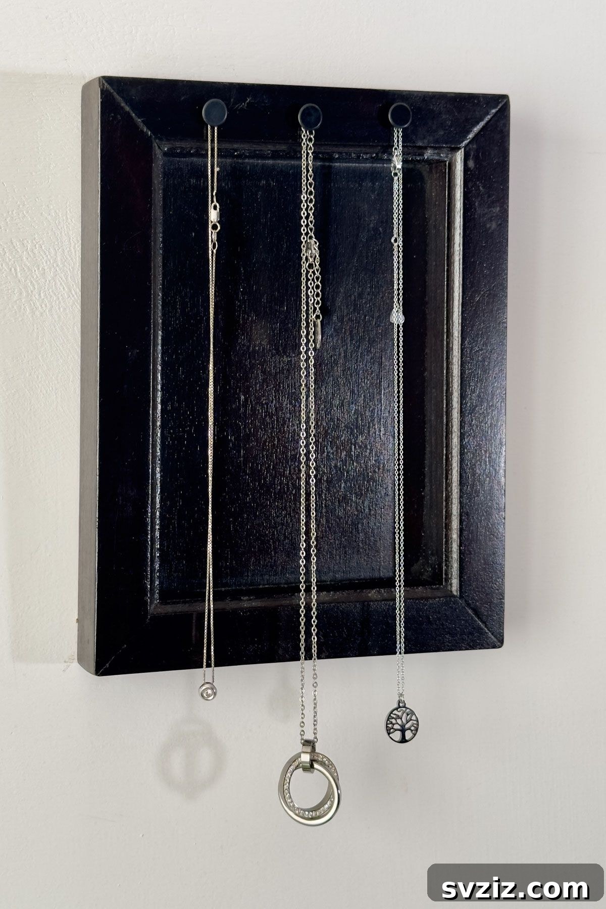 Elegant DIY jewelry storage: organizing necklaces with a repurposed frame