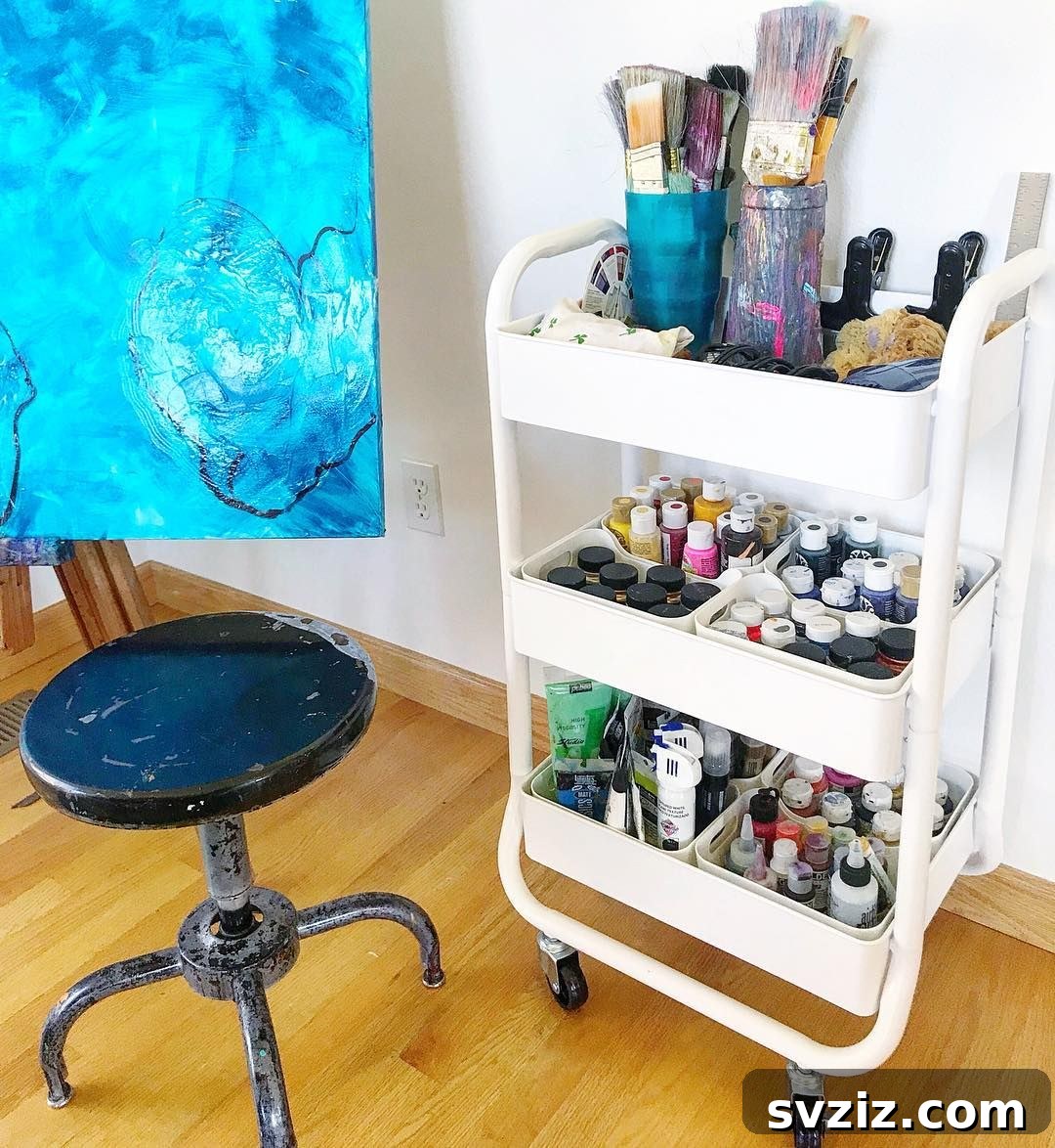IKEA cart organized with painting supplies, brushes, and tubes of paint