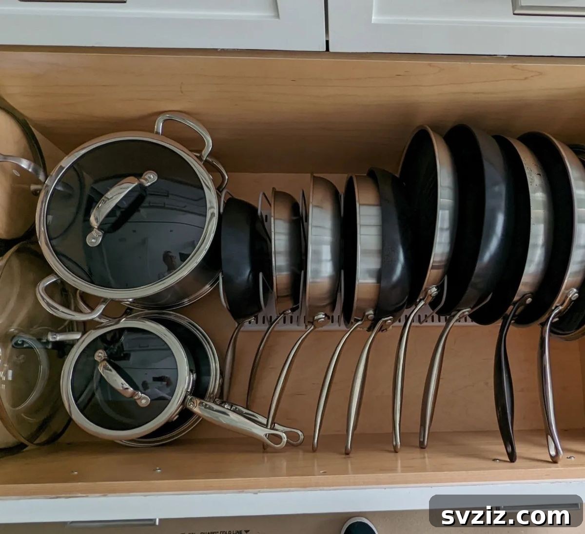 31 Genius Vertical Storage Hacks 14 Vertical pan rack organizer in a kitchen cabinet