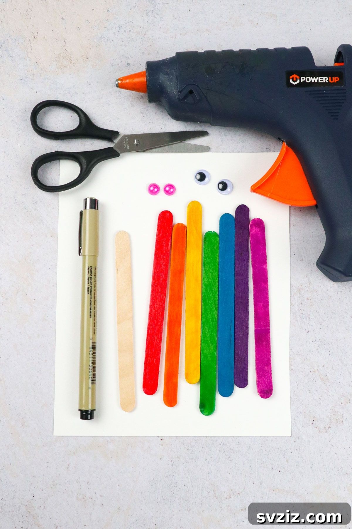 Popsicle Stick Rainbow Extravaganza 3 Craft supplies for Rainbow Popsicle Stick Craft laid out on a table