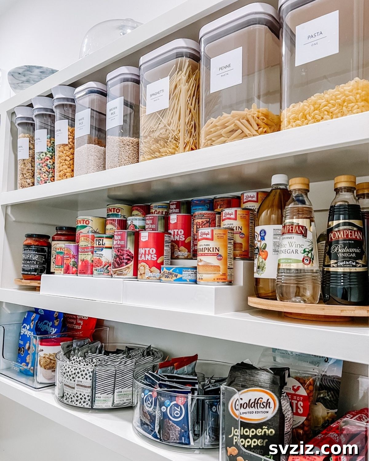 Well-organized pantry with clear containers, Lazy Susans, and can holders