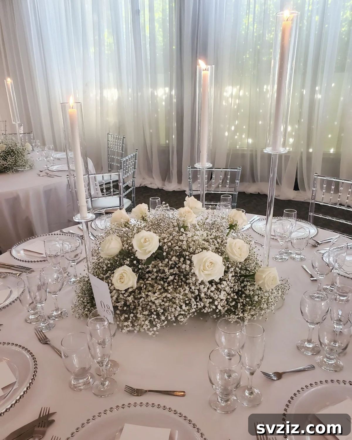 27 Elegant Round Table Wedding Centerpiece Inspirations 11 Fairy-tale wedding centerpiece with delicate Baby's Breath and towering glass candle holders.