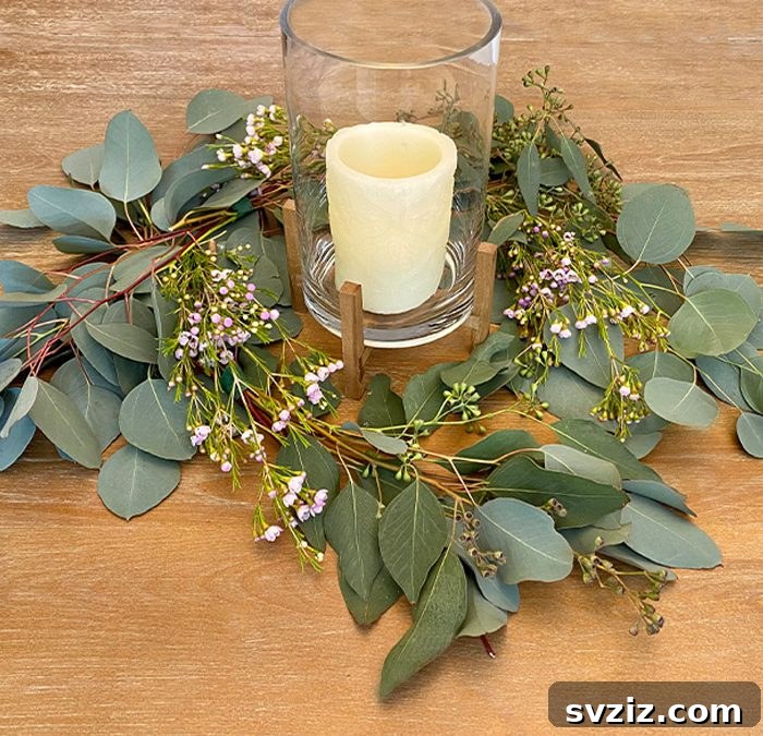 27 Elegant Round Table Wedding Centerpiece Inspirations 15 DIY Eucalyptus wedding centerpiece with unscented pillar candles in glass jars.