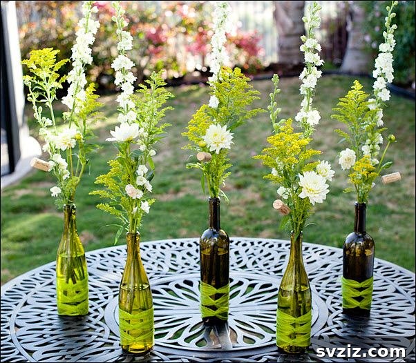 27 Elegant Round Table Wedding Centerpiece Inspirations 17 DIY wedding reception centerpieces using repurposed wine bottles with flowers and ribbons.
