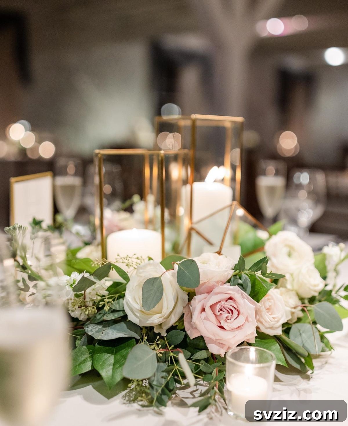 27 Elegant Round Table Wedding Centerpiece Inspirations 24 Romantic wedding centerpiece with pink and white roses, pillar candles in rose gold hurricane holders.