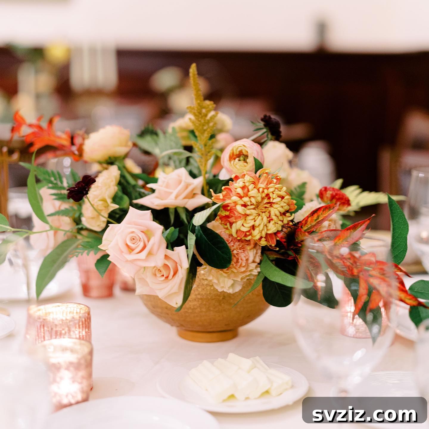 27 Elegant Round Table Wedding Centerpiece Inspirations 26 Lively wedding centerpiece with unexpected pops of orange, yellow, and brown florals.