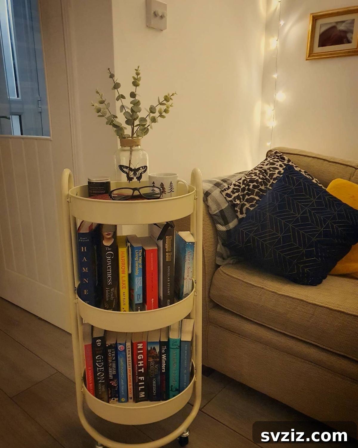 Rolling circular cart used for organizing books, with distinct tiers for different reading categories.