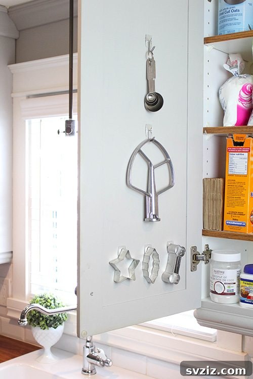Command Hooks in Kitchen Cabinets - Hidden storage for kitchen utensils.