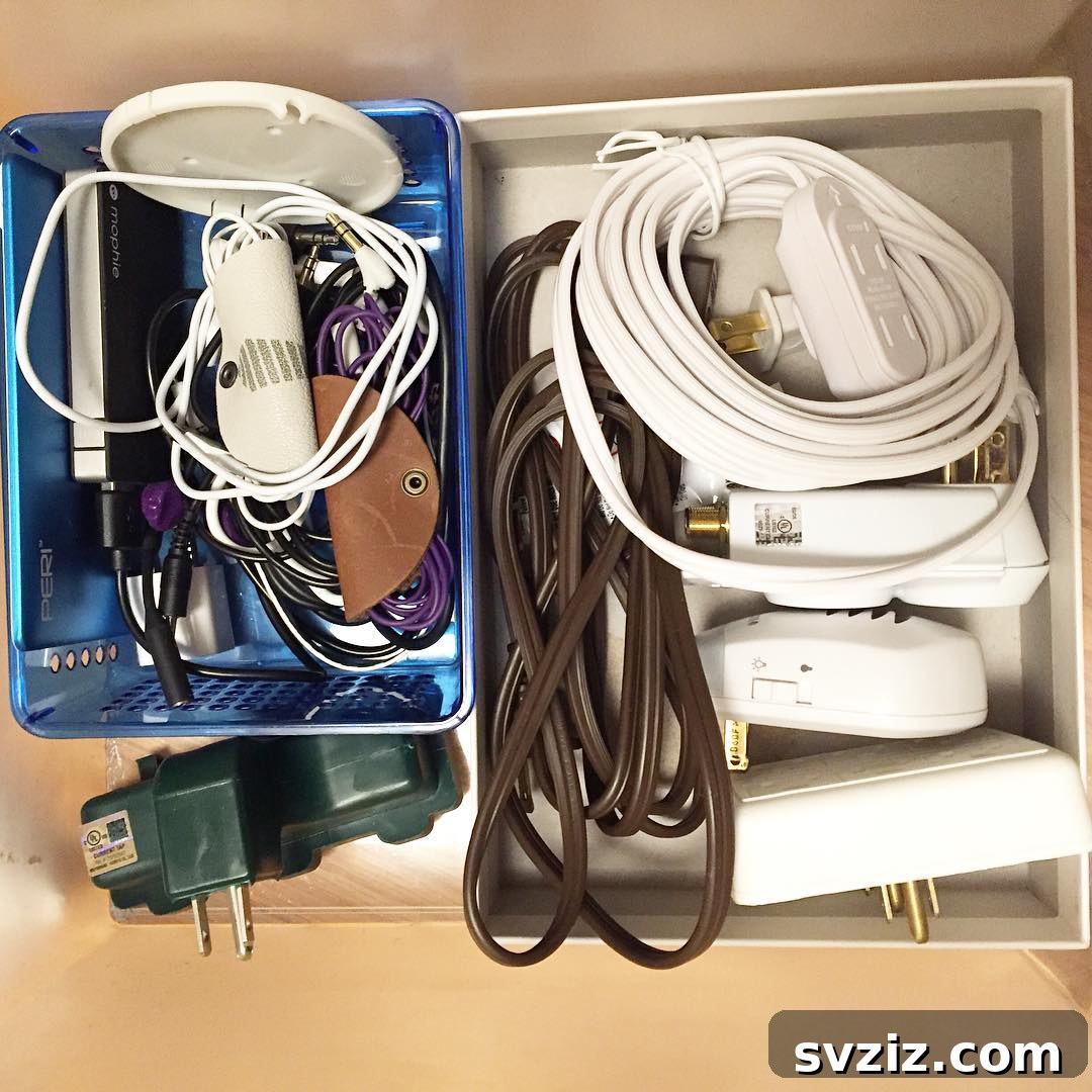Cluttered drawer with old chargers for unused electronics