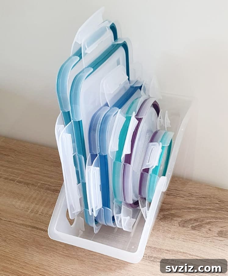 Cabinet overflowing with mismatched food storage containers and lids