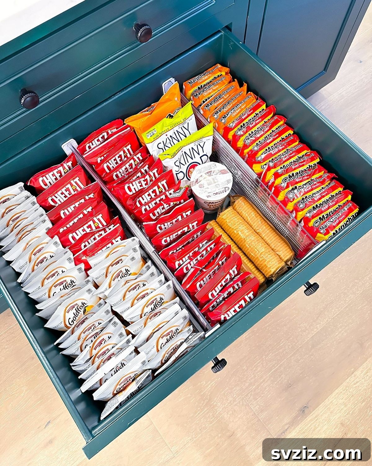 21 Genius Tricks to Tame Kitchen Clutter 4 Organized kitchen drawer with various snacks separated by dividers