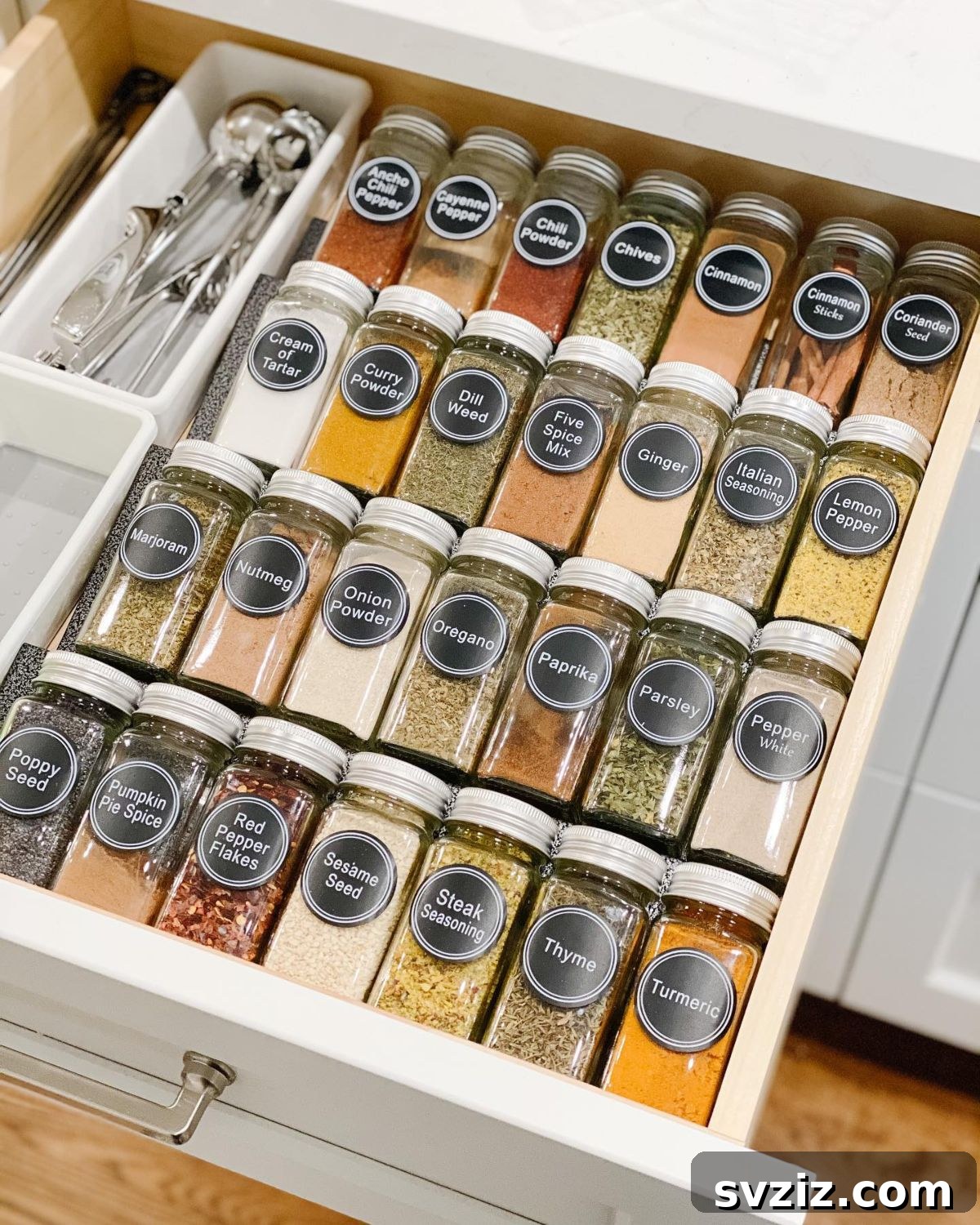 21 Genius Tricks to Tame Kitchen Clutter 5 Drawer organized with spice jars laid flat with labels facing up