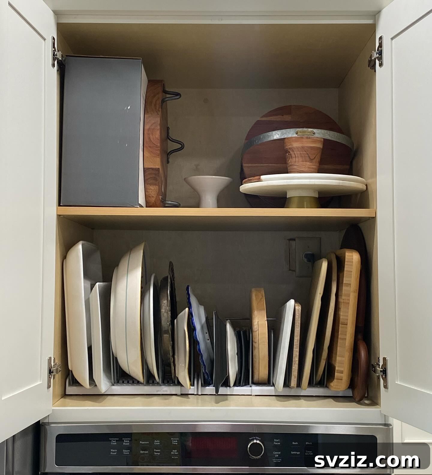 21 Genius Tricks to Tame Kitchen Clutter 7 Cabinet organized with a vertical tray and cutting board organizer