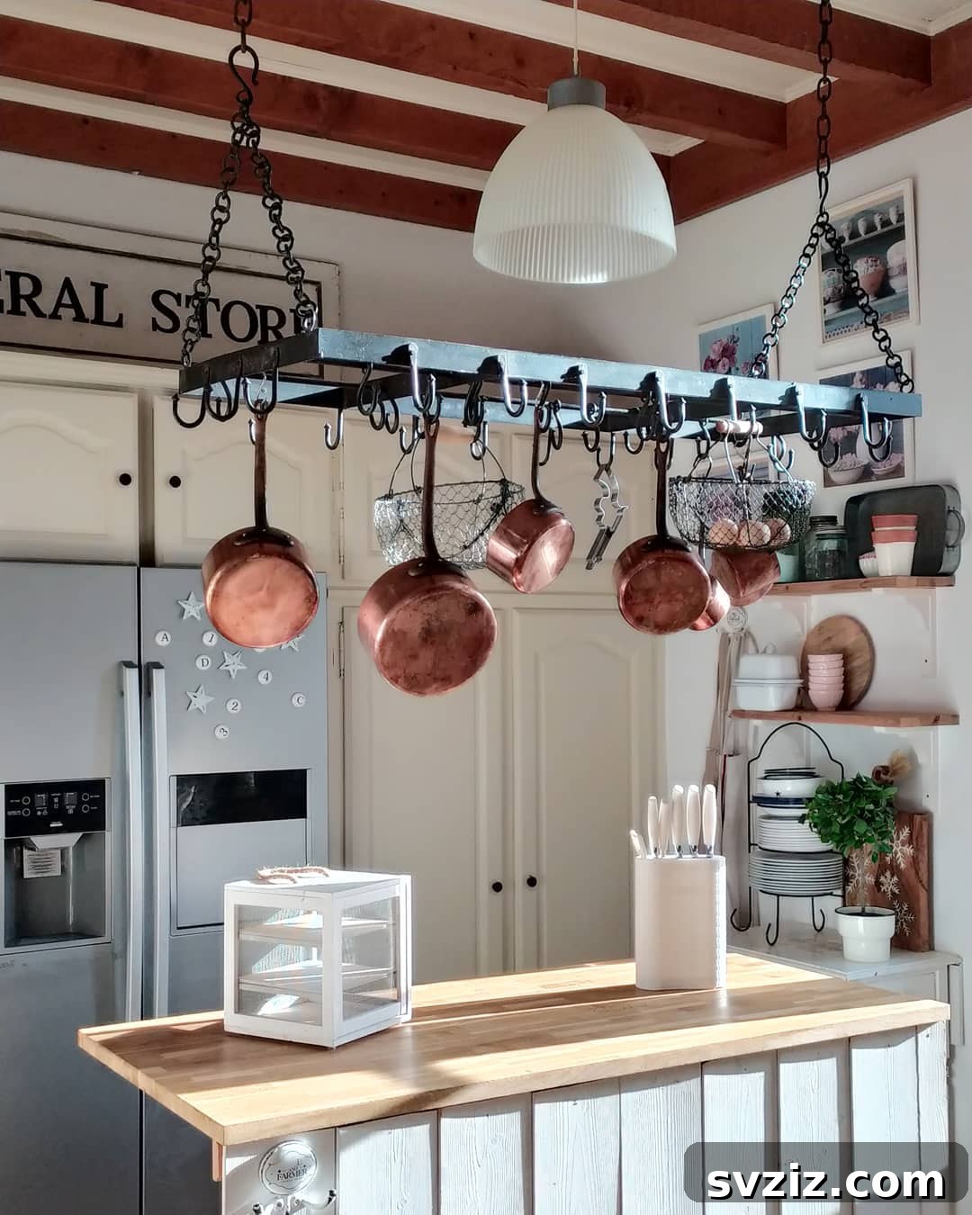25 Brilliant Storage Hacks for Tiny Kitchens 18 Kitchen with hanging pot and pan rack above counter