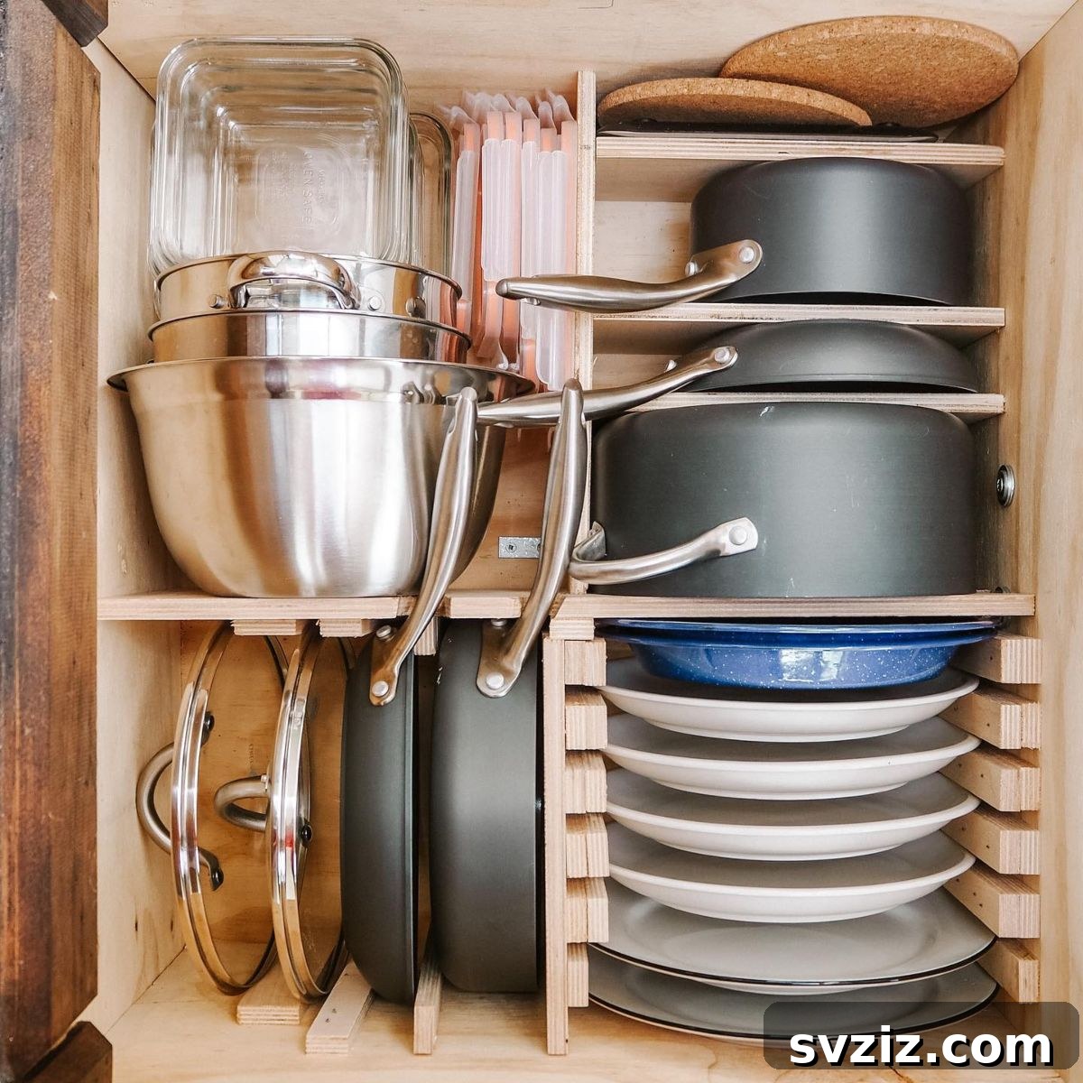 A kitchen drawer neatly organized with dividers, separating utensils and small kitchen tools.