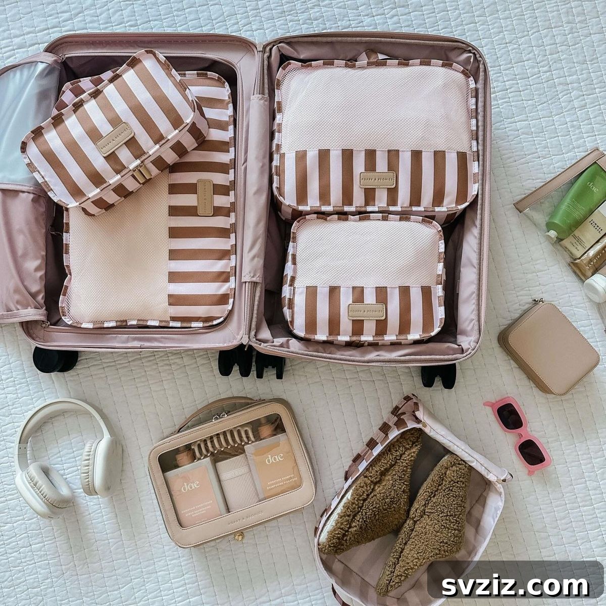 A suitcase organized with colorful packing cubes, each holding different categories of clothing for efficient travel.