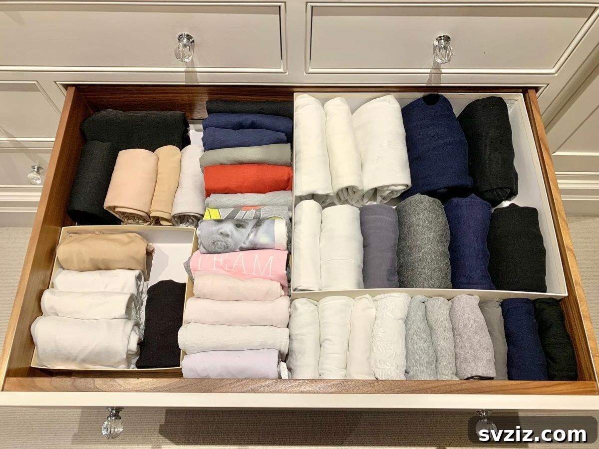 KonMari method: vertically folded and rolled clothes neatly stored in a drawer, maximizing space and visibility.