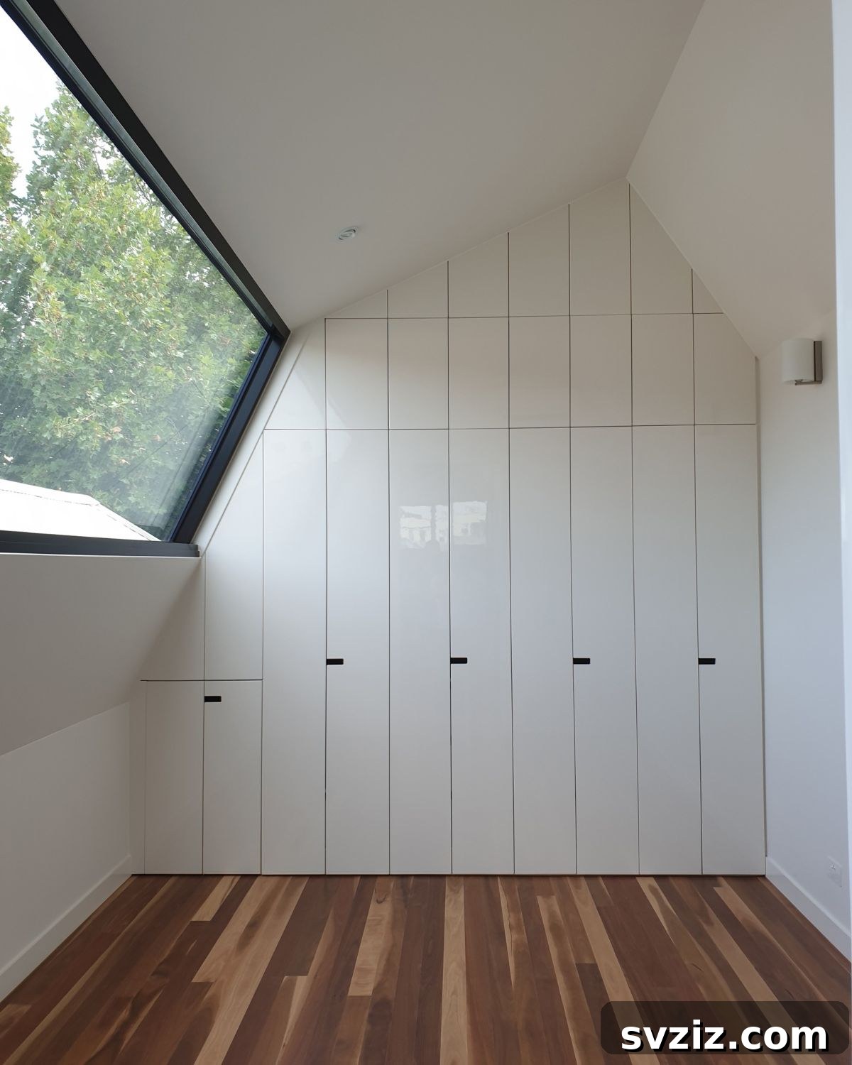 Transform Your Attic: Clever Organizing Secrets 12 Modern hidden storage access to an attic seamlessly integrated into a wall