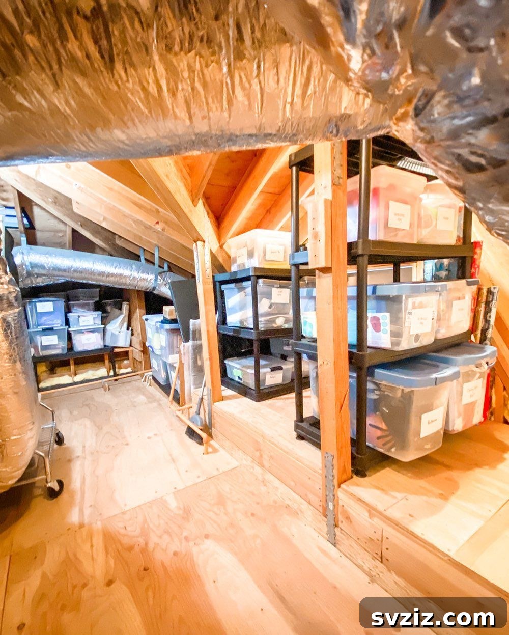 Transform Your Attic: Clever Organizing Secrets 5 Clear storage tubs neatly stacked in an attic, showing contents