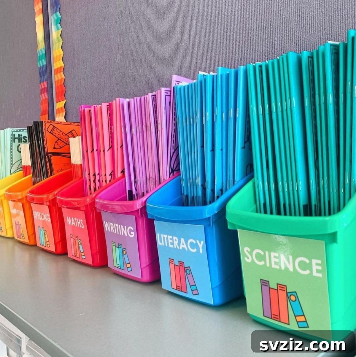 Colorful book box labels for different subjects in a classroom