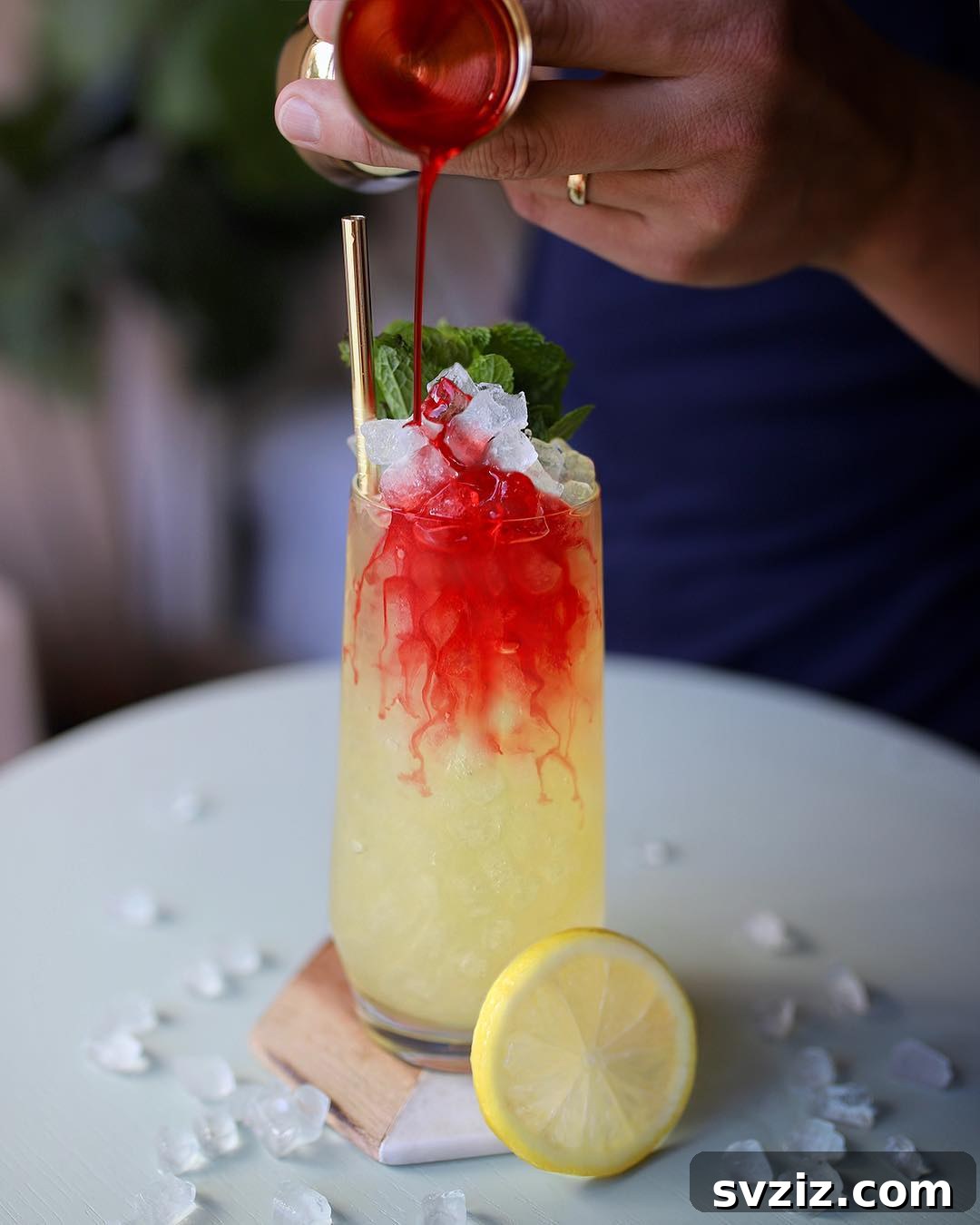 31 Terrifying Halloween Bash Concepts 14 Macabre Halloween cocktail called 'Corpse Revived' with red syrup