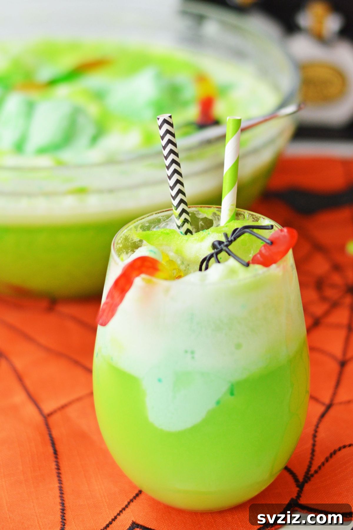 31 Terrifying Halloween Bash Concepts 3 Vibrant green Halloween punch with gummy worms and plastic spiders