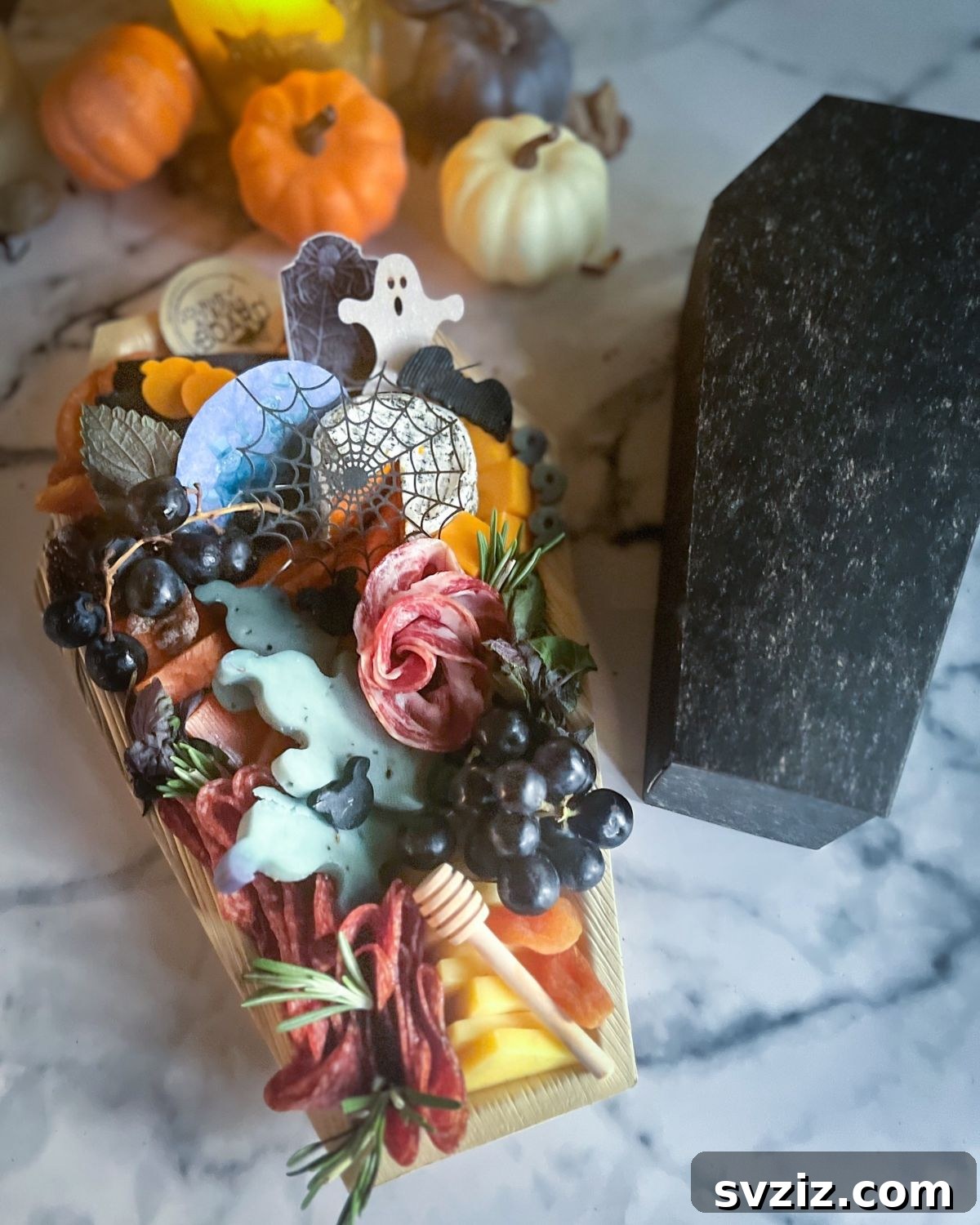 31 Terrifying Halloween Bash Concepts 24 Coffin-shaped Halloween charcuterie board with spooky snacks