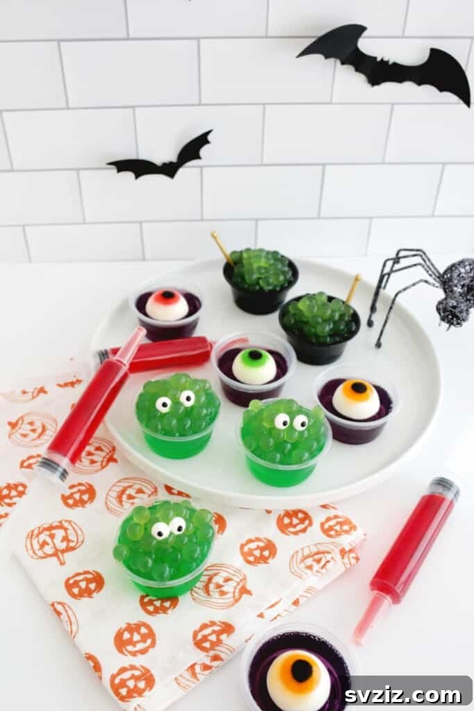 31 Terrifying Halloween Bash Concepts 27 Eerie green Halloween Jello Shots topped with gummy eyeballs