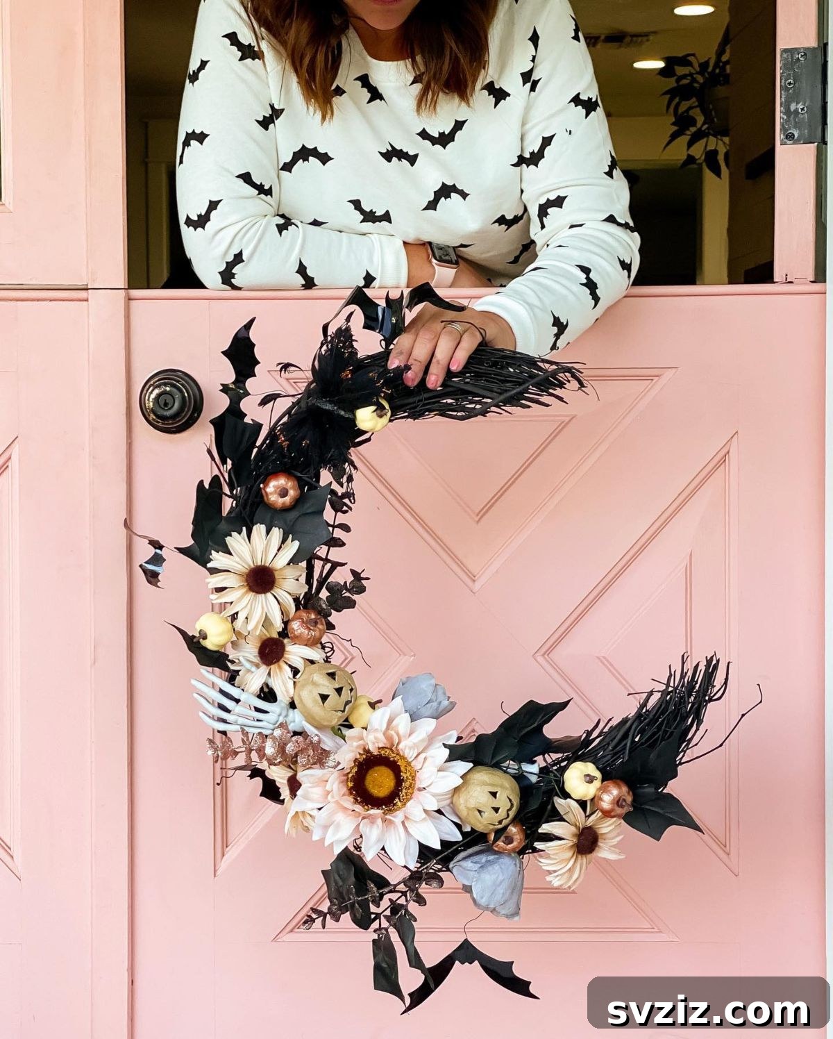 31 Terrifying Halloween Bash Concepts 5 Spooky black Halloween wreath with bats and feathers