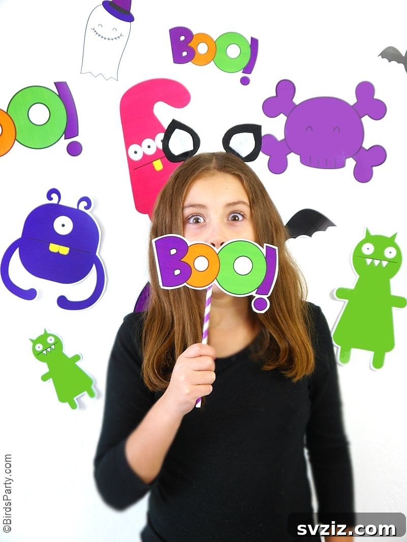 31 Terrifying Halloween Bash Concepts 10 DIY Halloween photo booth with monster cutouts and props