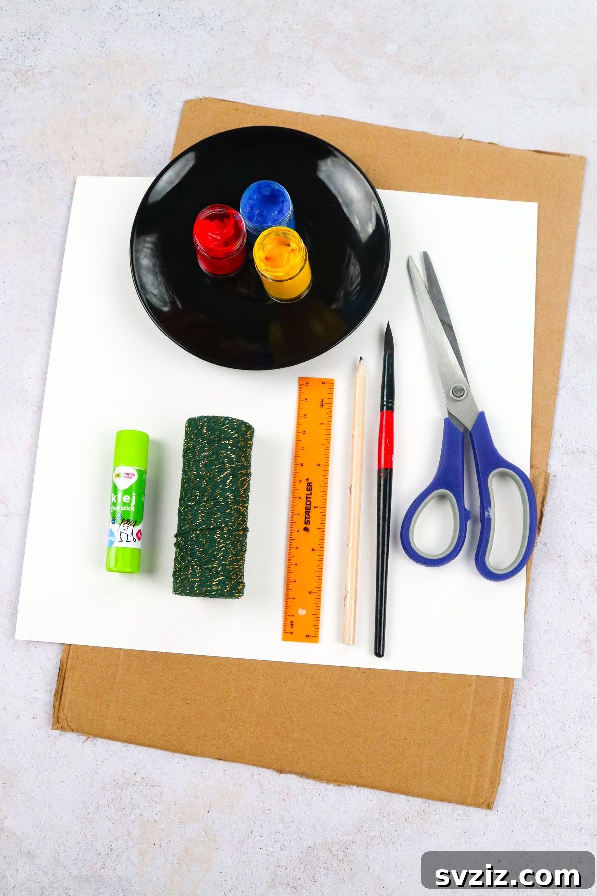 Essential craft supplies for making a paper spinner