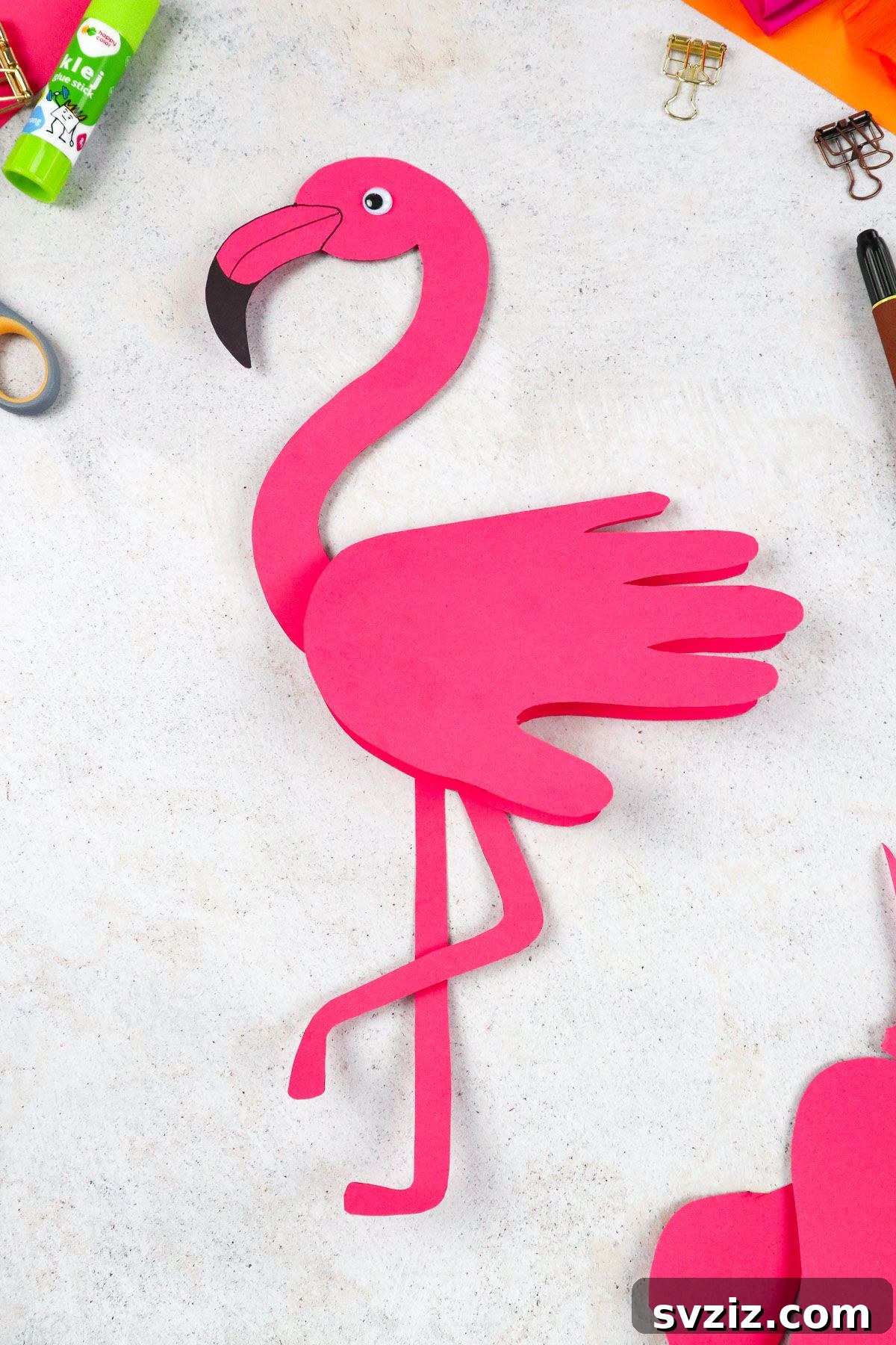 Flamingo Handprint Delight 11 A creative handprint flamingo craft displayed beautifully, showcasing its elegant design and vibrant pink color, on a wooden background.